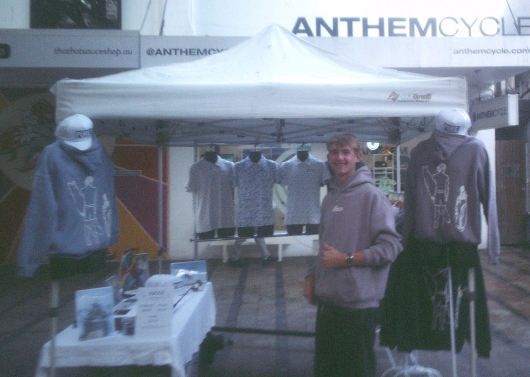 Axel Karlsson-Lacy posing in front of Axxa Golfs First ever market at the manly markets